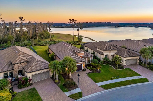 aerial view at dusk with a water view