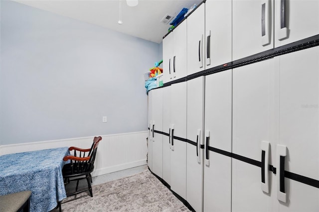 office space with a wainscoted wall and visible vents