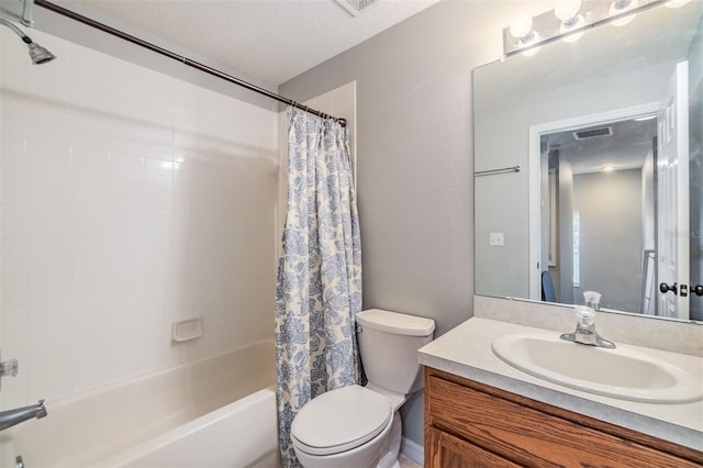 bathroom featuring a textured ceiling, toilet, visible vents, vanity, and shower / bath combo with shower curtain