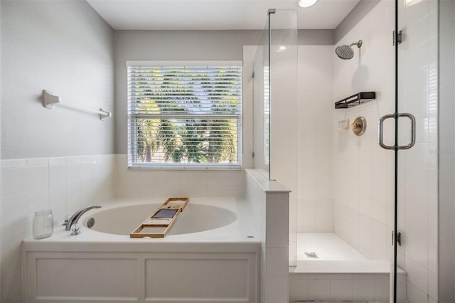 bathroom featuring a stall shower, plenty of natural light, and a bath