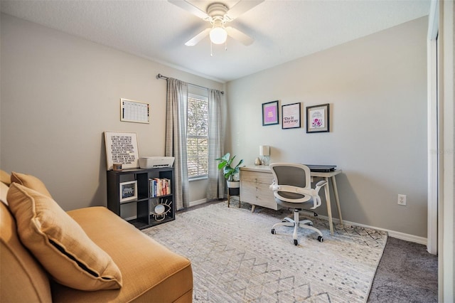 office area featuring carpet floors, a ceiling fan, and baseboards