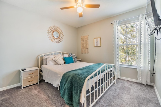 carpeted bedroom with a ceiling fan and baseboards