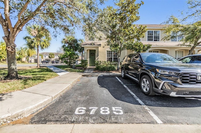 multi unit property with uncovered parking and stucco siding