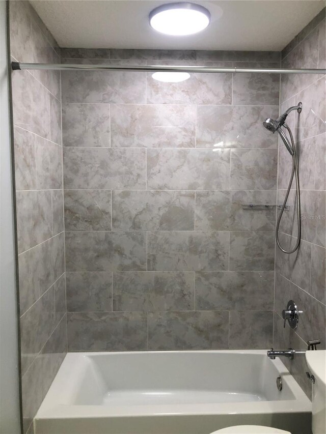 bathroom with shower / bathtub combination and toilet