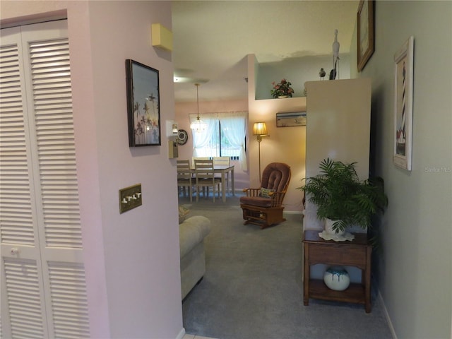 hall with carpet flooring and baseboards