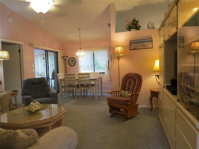 carpeted living room featuring vaulted ceiling, a chandelier, and baseboards