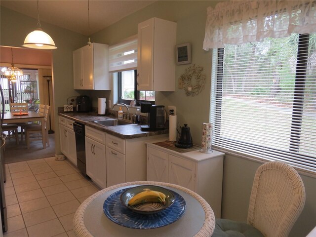 kitchen with pendant lighting, dark countertops, white cabinetry, a sink, and dishwasher