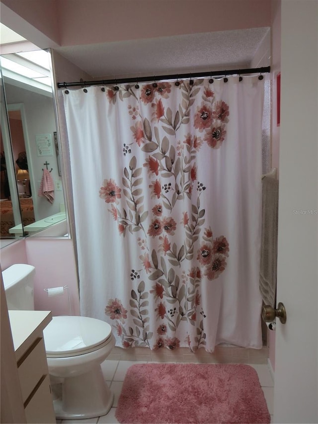 full bath with shower / bath combo with shower curtain, vanity, toilet, and tile patterned floors