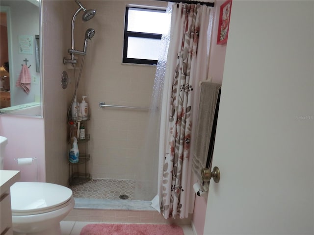 bathroom with a stall shower, vanity, and toilet