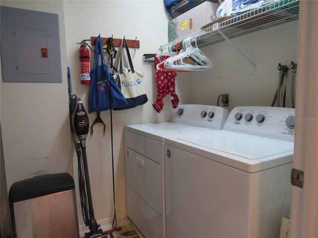 laundry area featuring laundry area, washing machine and dryer, and electric panel