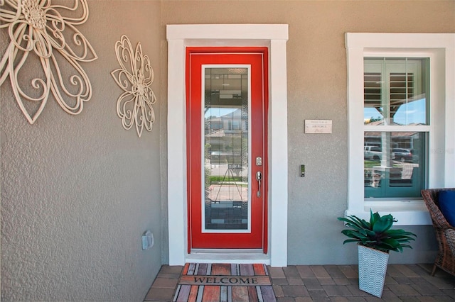 entrance to property featuring stucco siding