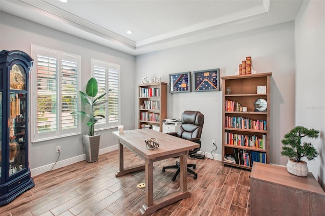 office space featuring baseboards, a tray ceiling, and wood tiled floor