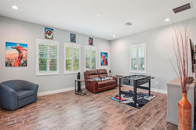 sitting room with recessed lighting, visible vents, baseboards, and wood tiled floor