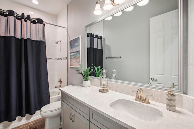 full bathroom featuring wood finished floors, toilet, vanity, and shower / bath combo