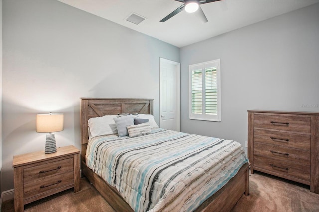 carpeted bedroom with visible vents and a ceiling fan