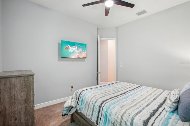 carpeted bedroom featuring visible vents, baseboards, and ceiling fan