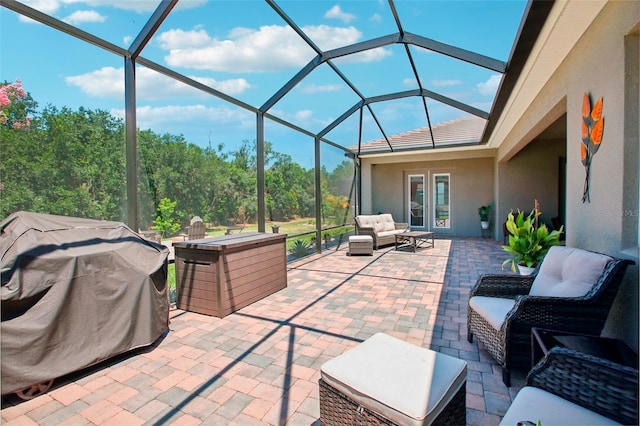 view of patio / terrace with outdoor lounge area, glass enclosure, and grilling area