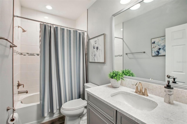 bathroom with vanity, toilet, and shower / bathtub combination with curtain