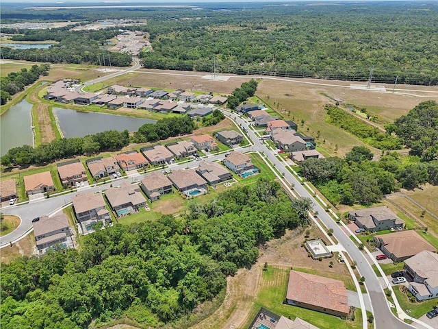 drone / aerial view featuring a water view and a residential view