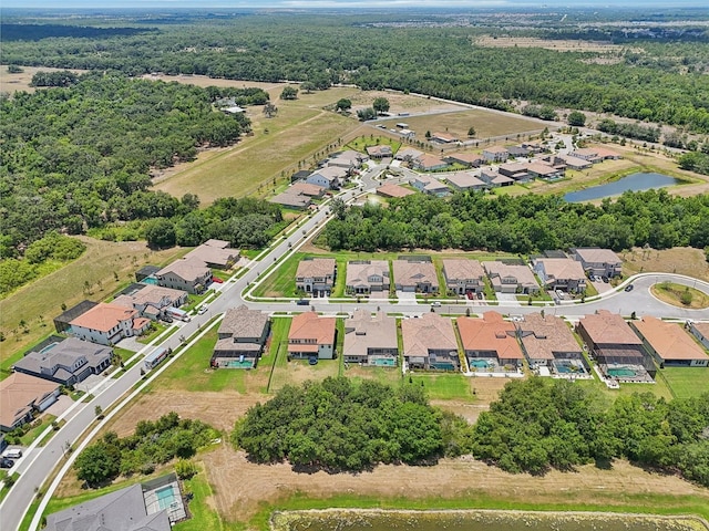 drone / aerial view with a residential view and a water view