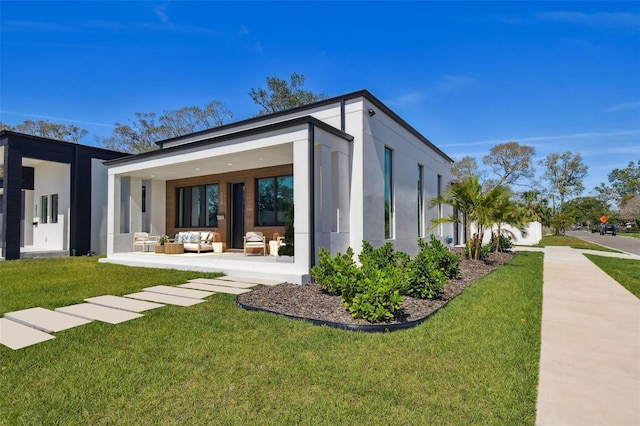 exterior space featuring an outdoor hangout area, a yard, a patio, and stucco siding