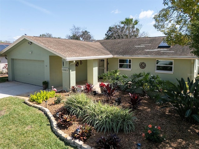 ranch-style home featuring an attached garage, roof with shingles, concrete driveway, and stucco siding