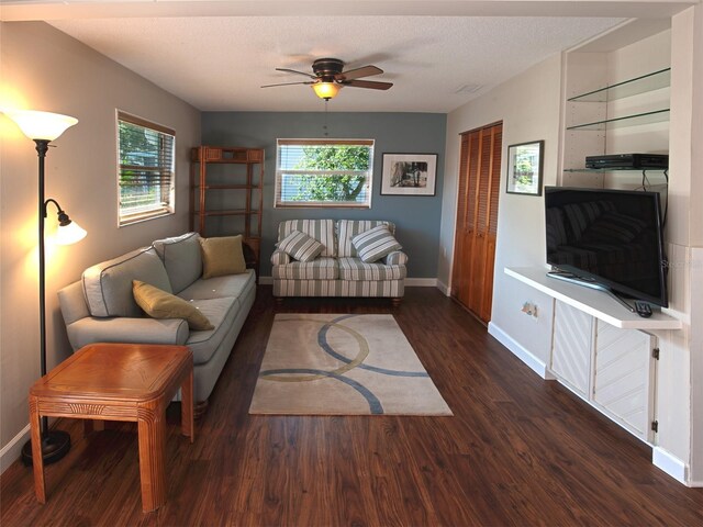 living area with a healthy amount of sunlight, baseboards, and wood finished floors