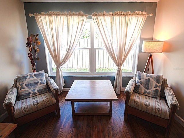 living area featuring plenty of natural light, baseboards, and wood finished floors