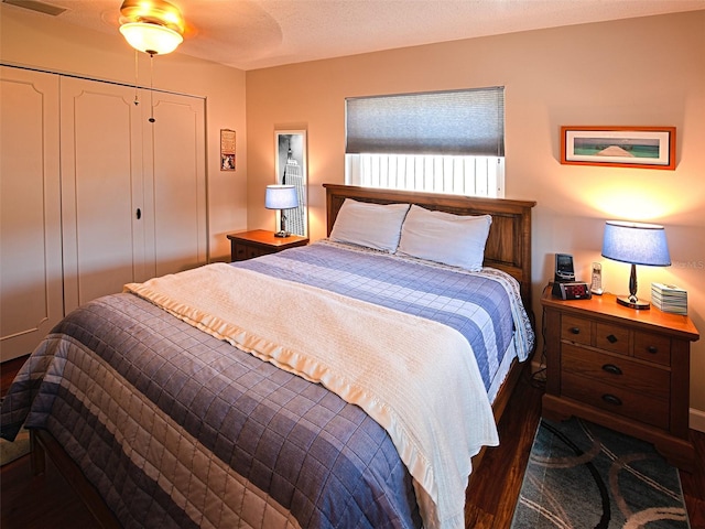 bedroom featuring a closet, a textured ceiling, and wood finished floors