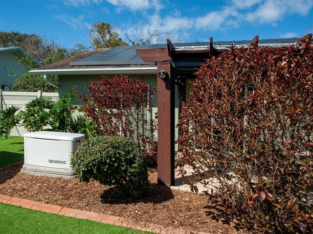 exterior details with a downspout, fence, and a power unit