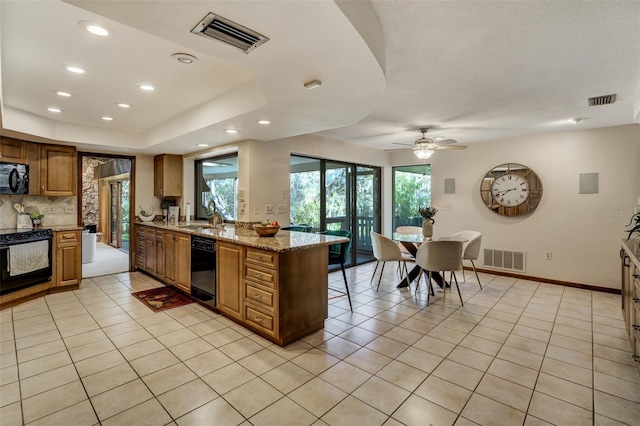 kitchen with light stone counters, brown cabinets, visible vents, light tile patterned flooring, and black appliances