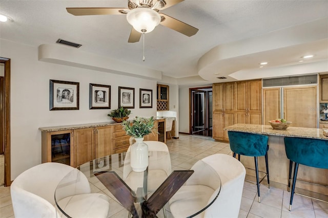 dining space with light tile patterned floors, visible vents, and a ceiling fan