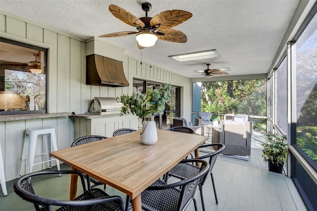 sunroom / solarium featuring ceiling fan