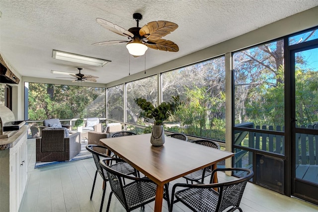 sunroom / solarium featuring ceiling fan and a wealth of natural light