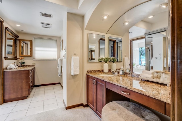 full bathroom with tile patterned flooring, visible vents, baseboards, and vanity