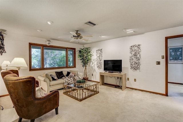 living area featuring baseboards, a ceiling fan, visible vents, and light colored carpet