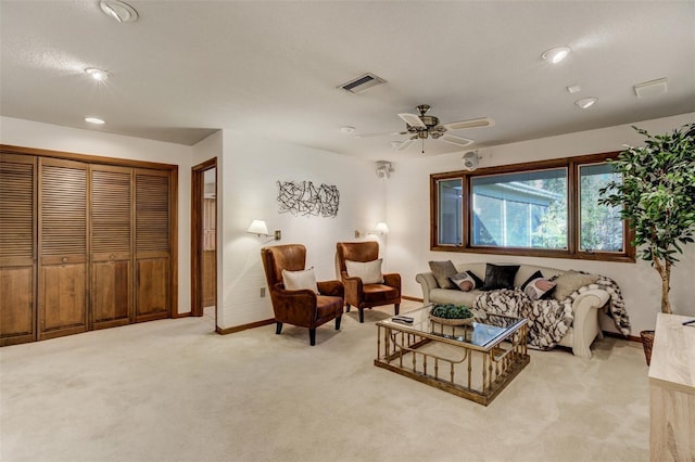 living room with visible vents, ceiling fan, light carpet, and baseboards