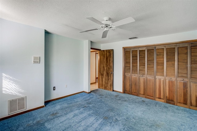 unfurnished bedroom with baseboards, a textured ceiling, visible vents, and light colored carpet