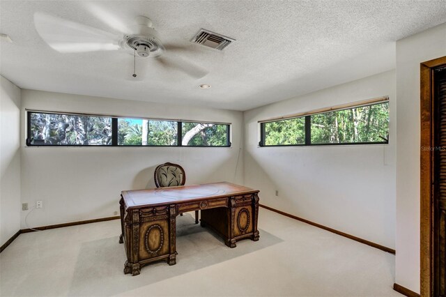 home office featuring baseboards, visible vents, and light colored carpet