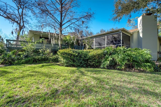 view of yard with a sunroom