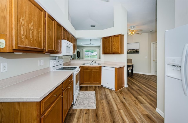 18186 Sandy Pointe Dr, Tampa, FL 33647 - kitchen with a ceiling fan, a sink, brown cabinetry, and white appliances