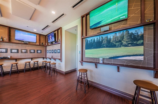 18186 Sandy Pointe Dr, Tampa, FL 33647 - bar featuring baseboards, a textured ceiling, visible vents, and wood finished floors