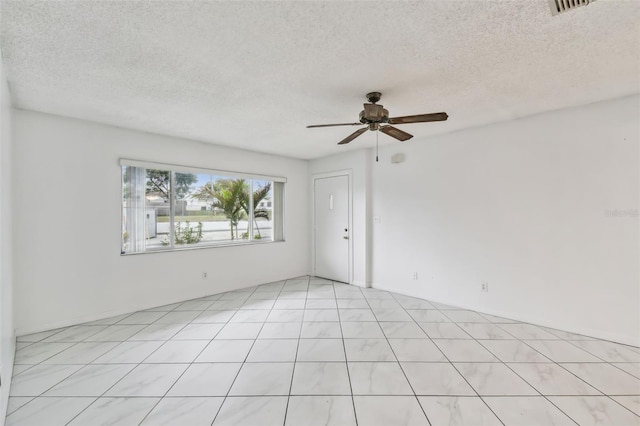 unfurnished room featuring ceiling fan, a textured ceiling, and visible vents