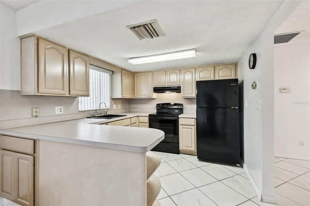 kitchen with under cabinet range hood, a sink, visible vents, light countertops, and black appliances