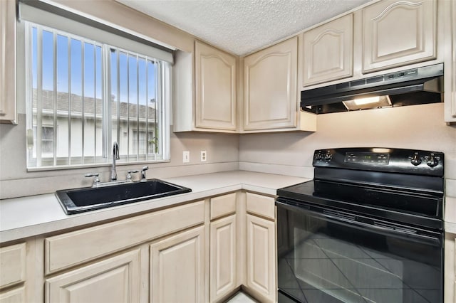 kitchen with a sink, under cabinet range hood, light countertops, and black range with electric stovetop