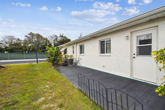 view of yard featuring central AC and fence