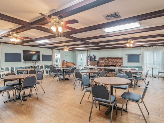 dining room with coffered ceiling, beam ceiling, visible vents, and light wood-style flooring