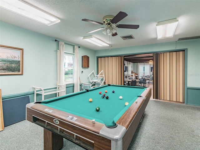 rec room with billiards, visible vents, ceiling fan, a textured ceiling, and dark carpet