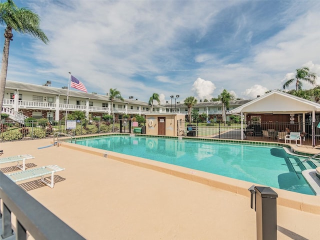 pool featuring fence and a patio