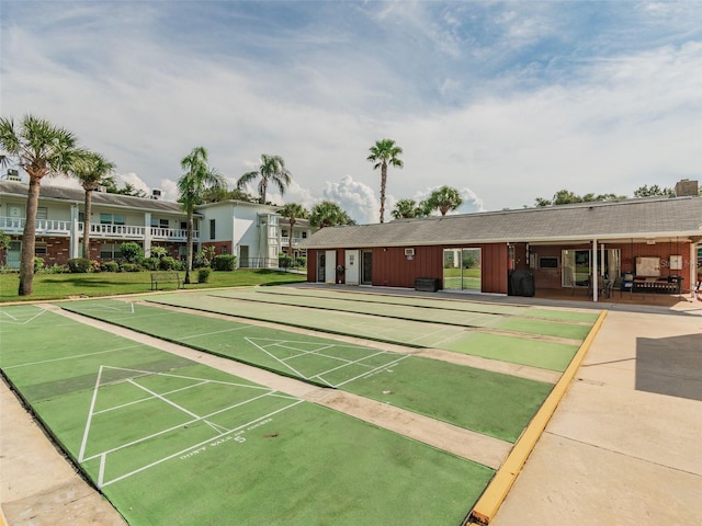 view of property's community featuring shuffleboard